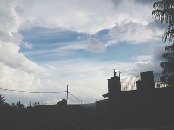 Low angle view of built structure against cloudy sky