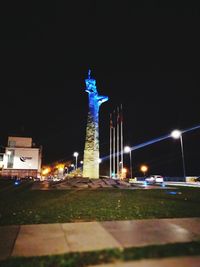 Statue in city at night
