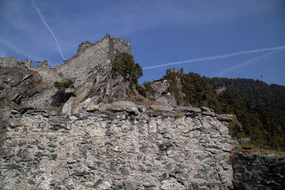 Low angle view of rock formation against sky