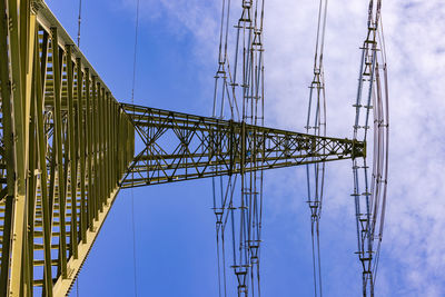 Huge high-voltage pylon, a nexus for power lines, towers against the sky