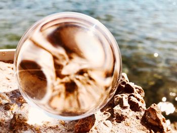High angle view of glass of water on rock