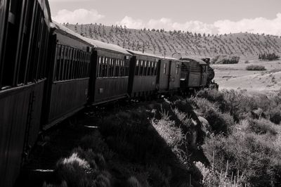 Train on railroad track against sky