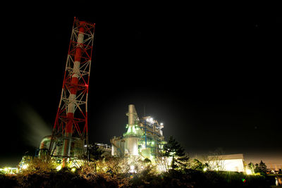 Low angle view of illuminated buildings against sky at night