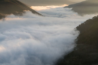 Scenic view of cloudscape and mountains against sky