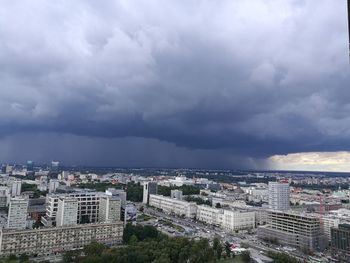 High angle view of cityscape against storm clouds