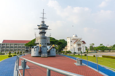 Lighthouse amidst buildings against sky