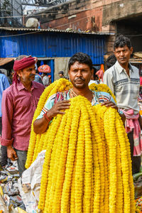 Portrait of a smiling young people at market stall