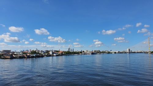 Scenic view of sea by city against sky