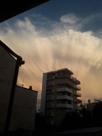 Low angle view of building against sky at sunset