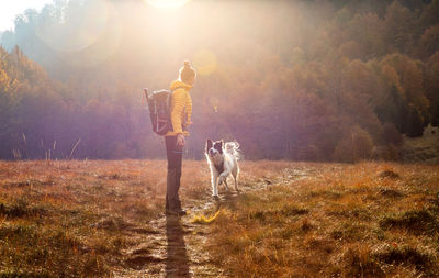 Man with dog standing on street