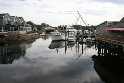 Boats moored at harbor in city