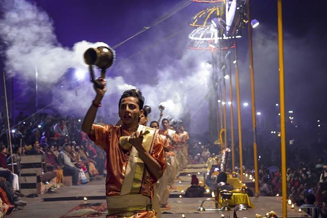 statue, illuminated, sculpture, human representation, sky, art and craft, night, street, arts culture and entertainment, art, low angle view, lighting equipment, built structure, street light, incidental people, creativity, building exterior, architecture, large group of people