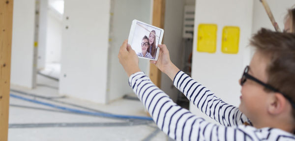 Side view of woman using mobile phone