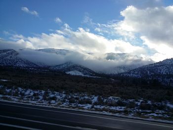 Scenic view of snow covered mountains against sky