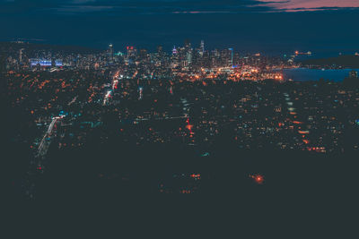 High angle view of illuminated city buildings at night