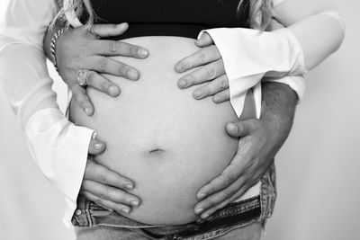 Cropped image of beautiful pregnant woman and her husband.