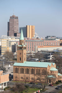 Buildings in city against clear sky