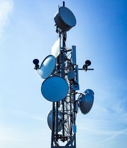 Low angle view of communications tower against sky