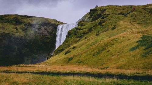 Scenic view of skógafoss waterfall against sky, iceland