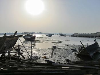 Boats moored in sea against clear sky