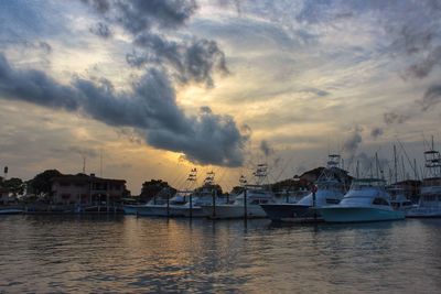 Boat in sea against cloudy sky