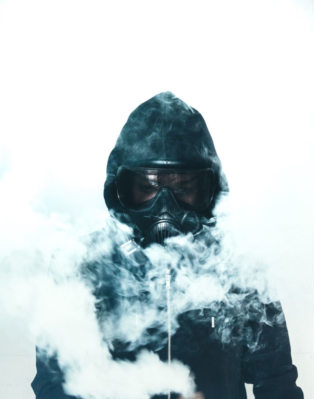 MAN LOOKING AT CAMERA AGAINST SKY DURING WINTER