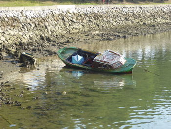 Abandoned boat moored in water