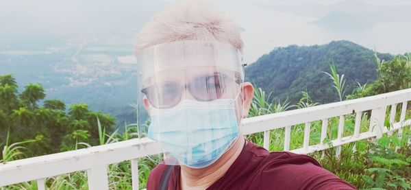Portrait of man standing against plants