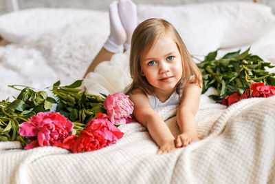 Portrait of smiling girl lying on sofa