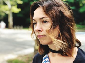 Close-up of thoughtful woman looking away in park