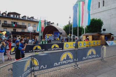 People on street against buildings in city