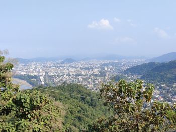 Aerial view of city and buildings against sky