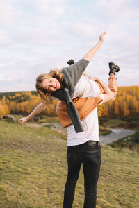 Happy people in love are travel hike in nature in the autumn forest. romantic trip to countryside