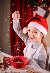 Portrait of smiling woman holding christmas tree