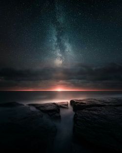 Scenic view of sea against sky at night