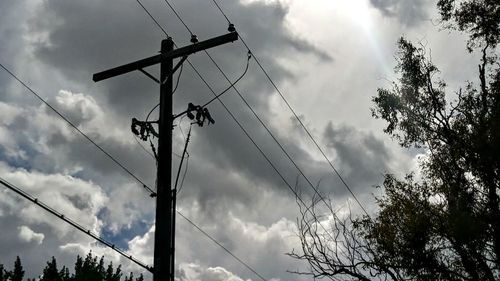 Low angle view of electricity pylon against sky