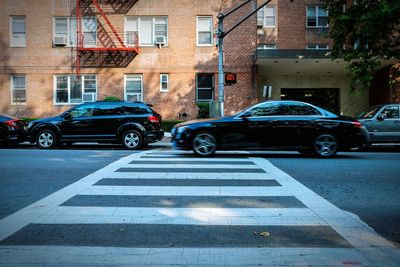 Cars parked on road against buildings in city