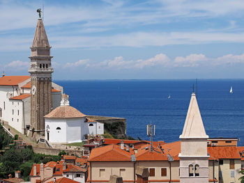 Townscape by sea against sky in city