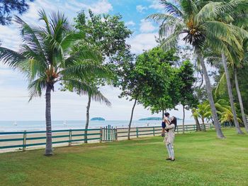 Full length of woman on palm tree