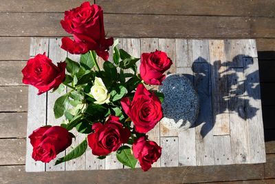 High angle view of rose bouquet against red wall