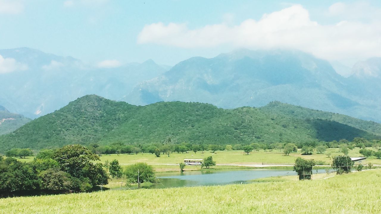 mountain, mountain range, landscape, tranquil scene, tranquility, scenics, grass, beauty in nature, sky, nature, green color, non-urban scene, field, tree, countryside, cloud - sky, idyllic, hill, remote, valley