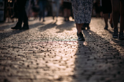 Low section of people walking on street