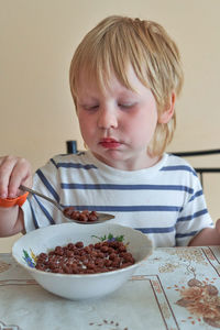 Portrait of cute girl eating food at home