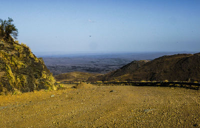 Scenic view of sea and mountains against sky