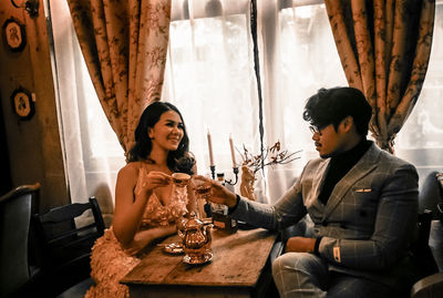 Young couple sitting on table at restaurant