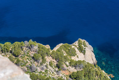 High angle view of cliff by sea