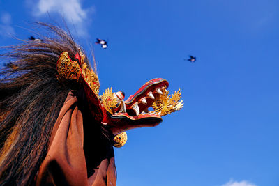 Low angle view of statue during balinese kite festival