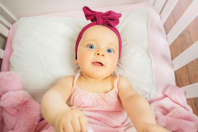 Portrait of cute baby boy sleeping on sofa at home