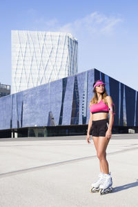 Portrait of young woman standing against sky