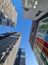 Low angle view of modern buildings against sky in city